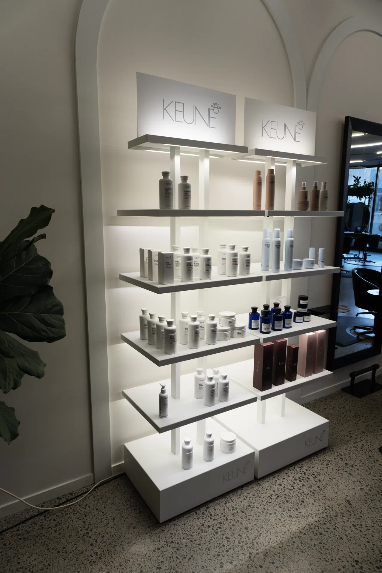 Keune styling products on the shelves beside the mirrors