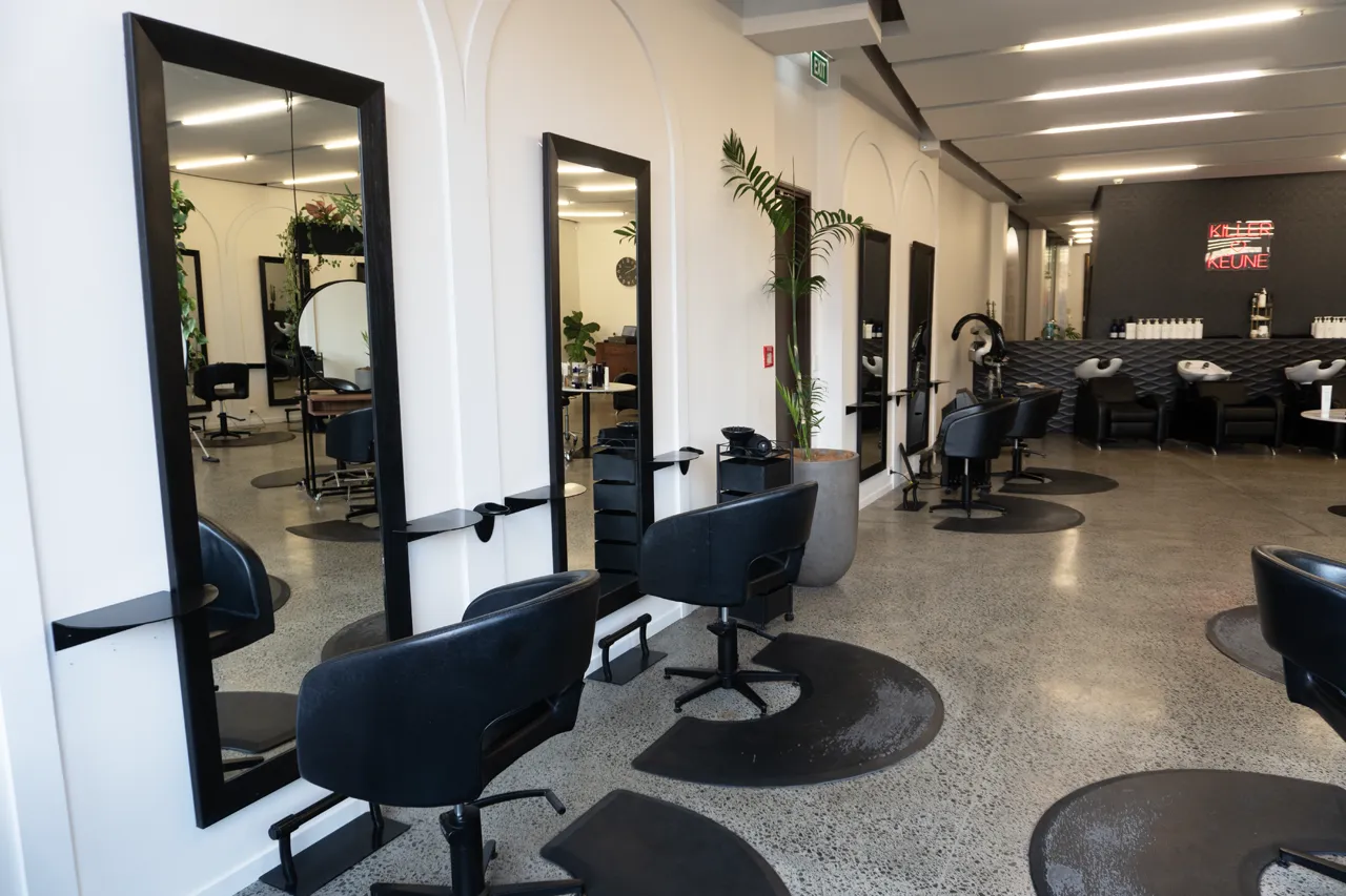 Mirrored styling stations along the polished concrete floor
