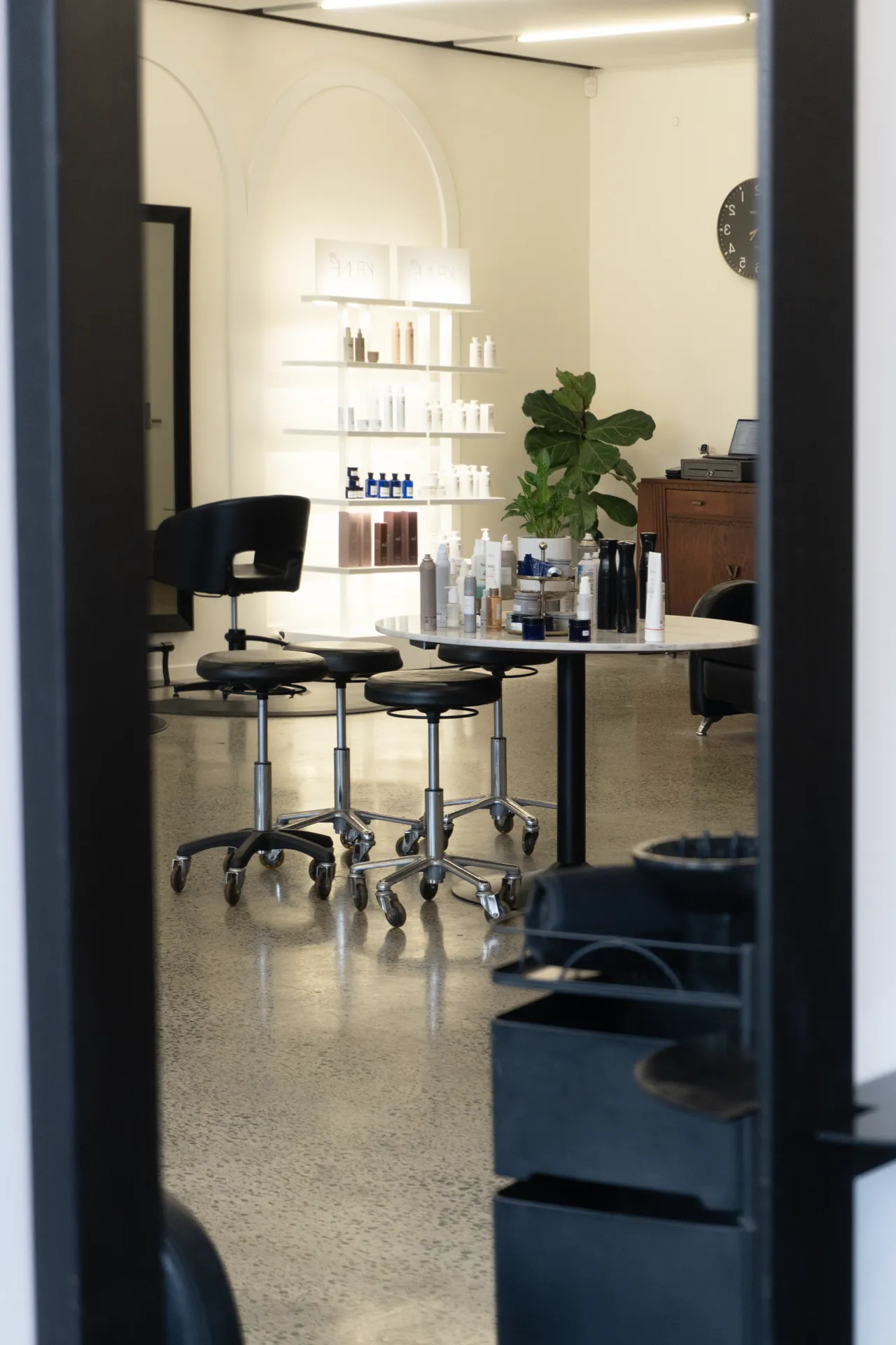 Styling stools and product shelving along the studio floor