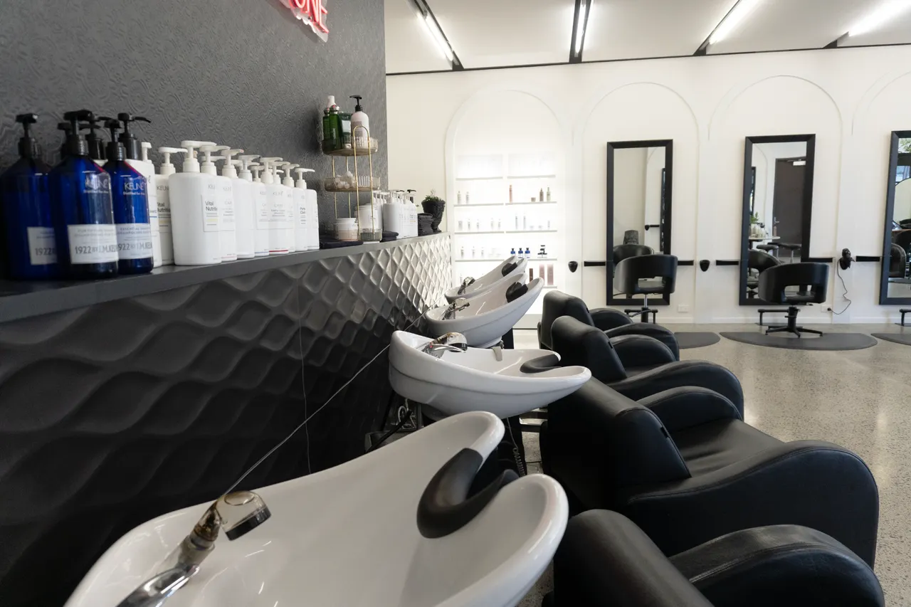 Wash basins and product bottles along the quilted wall